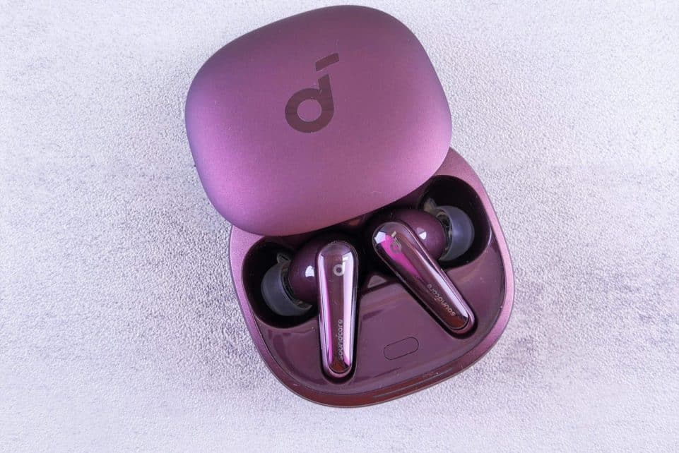 Modern purple earbuds resting in an open case, featuring glossy finish and sleek design.