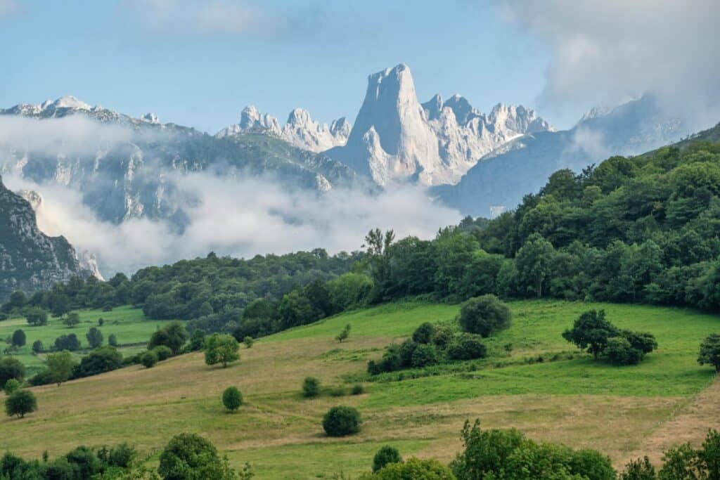 Beautiful landscape of the Picos de Europa mountains with green meadows in Asturias, Spain.