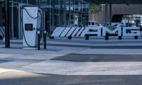Electric vehicle charging station at a modern business complex featuring sleek architectural design.