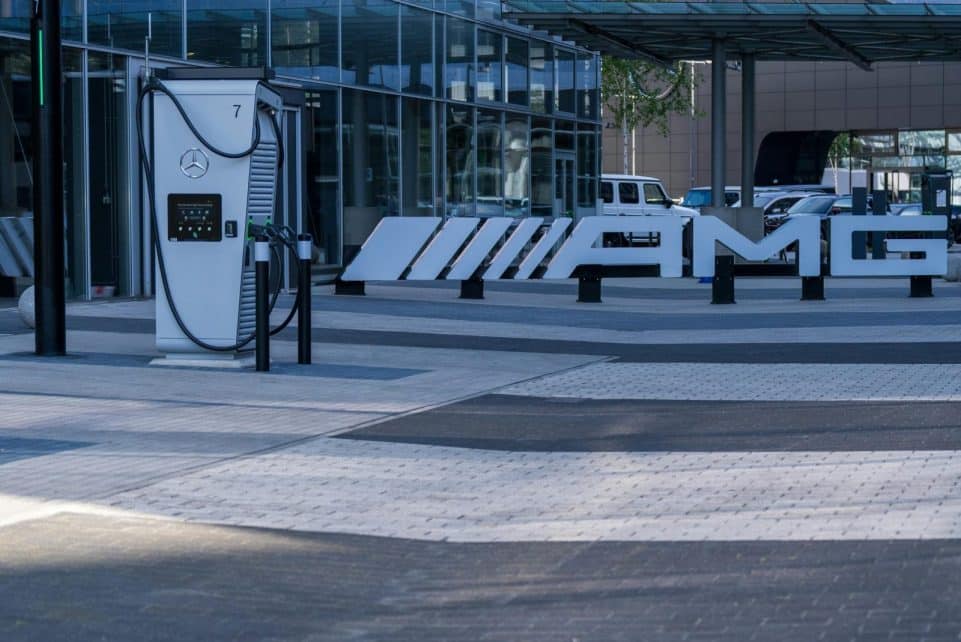 Electric vehicle charging station at a modern business complex featuring sleek architectural design.