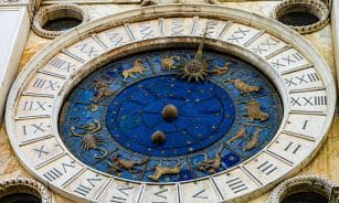Detailed view of the iconic Zodiac dial on St. Mark's Clock Tower in Venice, featuring astrological symbols.