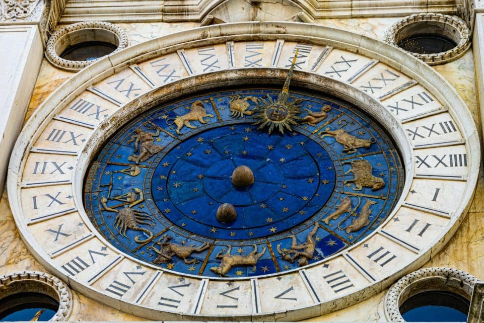 Detailed view of the iconic Zodiac dial on St. Mark's Clock Tower in Venice, featuring astrological symbols.