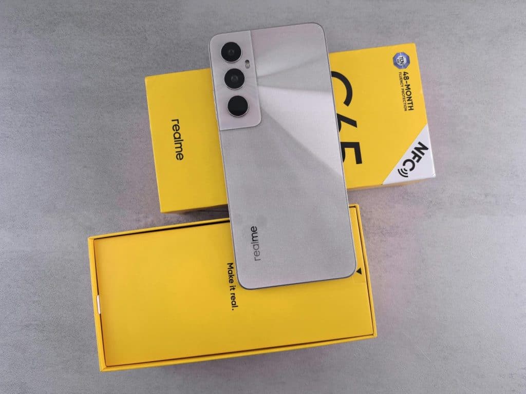 Close-up of realme smartphone placed on its box with standout yellow packaging.