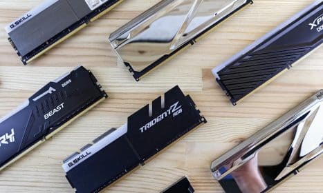 Top view of modern computer RAM sticks arranged on a wooden surface for technology enthusiasts.