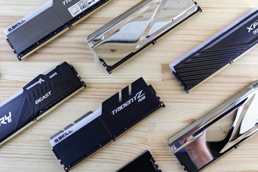 Top view of modern computer RAM sticks arranged on a wooden surface for technology enthusiasts.