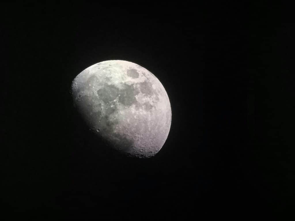 A high-definition photo of a crescent moon against the dark night sky, showcasing lunar details.