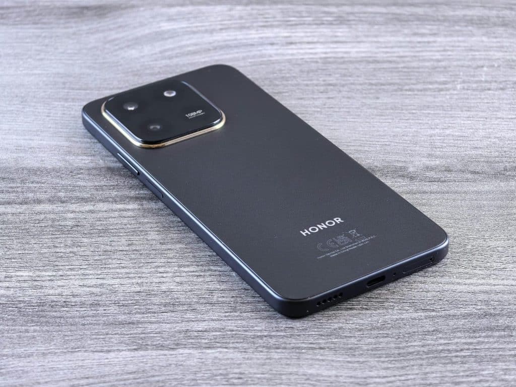 Close-up of a modern smartphone with a sleek design on a wooden surface.