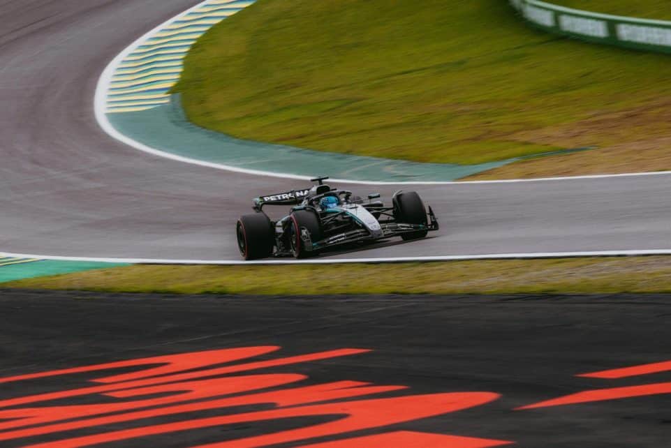 Dynamic shot of a Formula 1 car speeding around the Interlagos circuit in São Paulo.