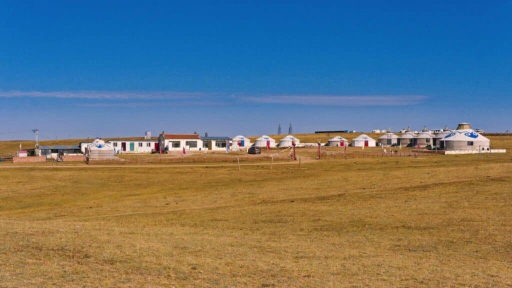 Scenic view of a traditional settlement with yurts in the vast grasslands of Inner Mongolia, China.