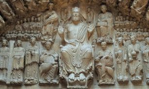 Detailed stone relief depicting religious figures and symbols at a historical site in London.
