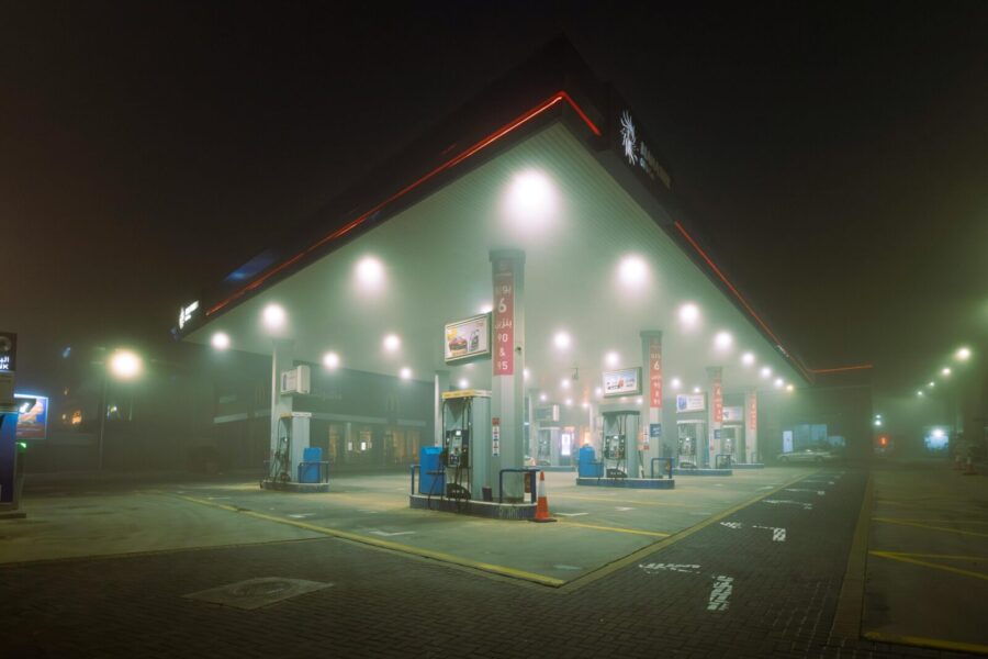 A foggy night scene at an illuminated gas station in Jordan, showcasing a mysterious and quiet atmosphere.