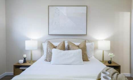 Cozy bedroom interior featuring modern decor and neutral color palette for home staging.