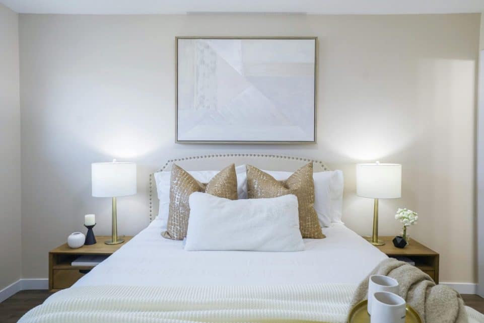 Cozy bedroom interior featuring modern decor and neutral color palette for home staging.