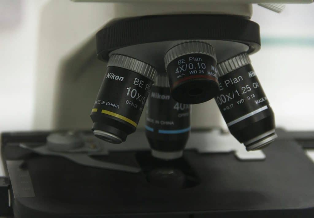 Detailed image of microscope lenses showcasing optical equipment for scientific research.