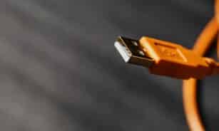 Detailed shot capturing an orange USB cable connector on a contrasting background.
