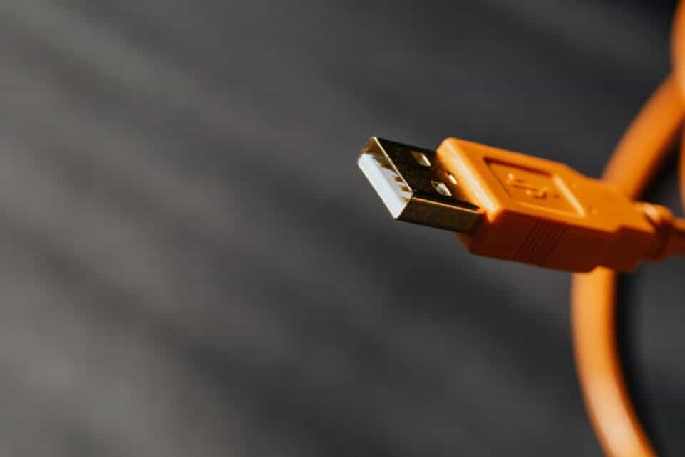 Detailed shot capturing an orange USB cable connector on a contrasting background.