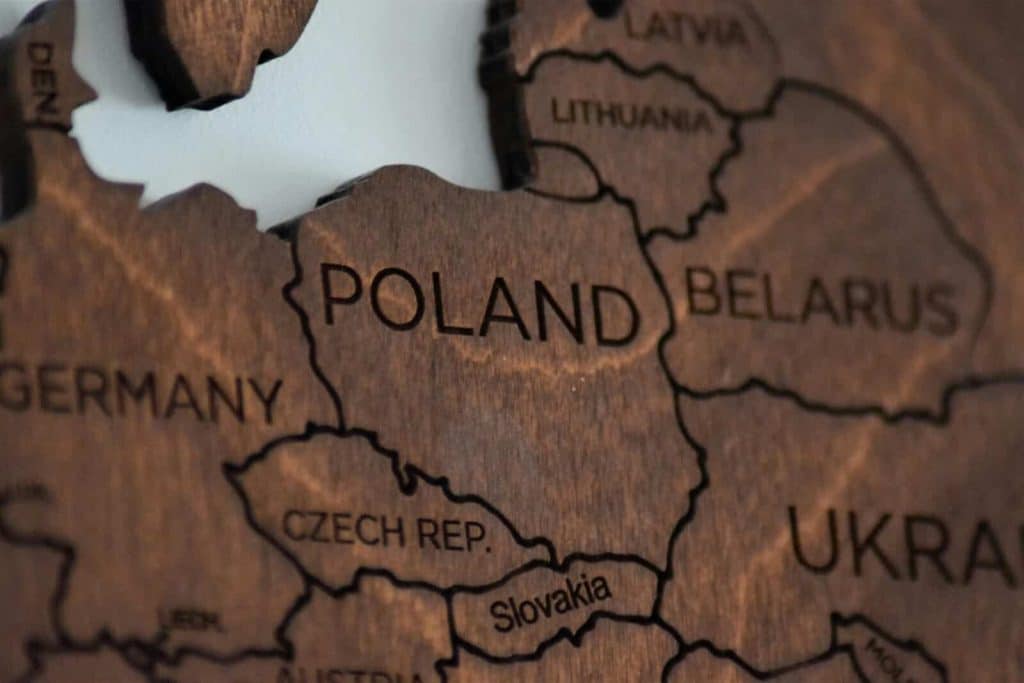 Detailed wooden map featuring Poland and surrounding countries.
