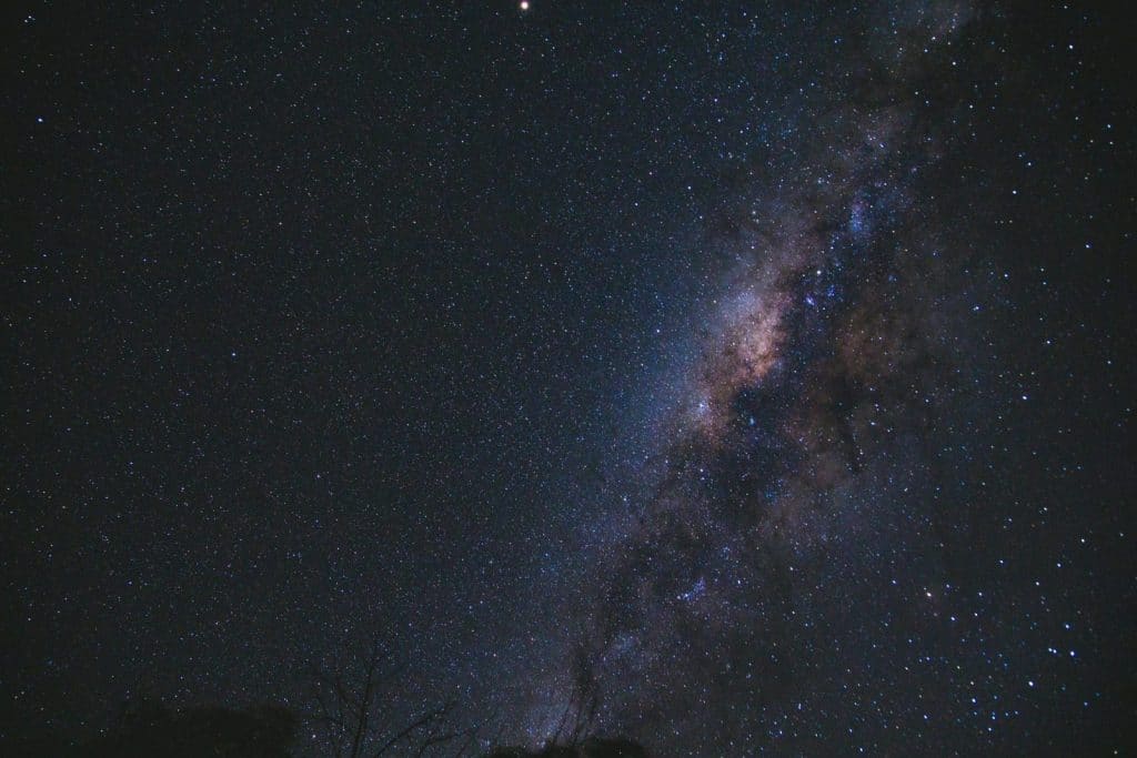 Capture the breathtaking beauty of the Milky Way and starry night sky in this mesmerizing photograph.