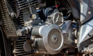 Detailed shot of a motorcycle engine showcasing intricate parts and craftsmanship.