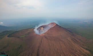A stunning aerial shot capturing Telica Volcano's dramatic landscape and smoke plume in Nicaragua.