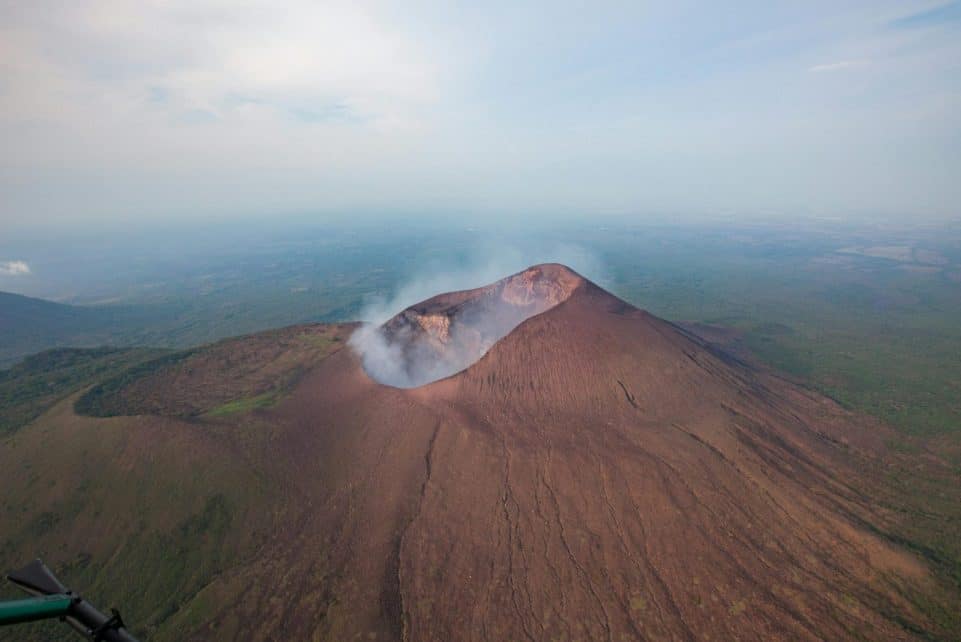 A stunning aerial shot capturing Telica Volcano's dramatic landscape and smoke plume in Nicaragua.
