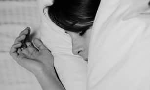 Close-up of a person sleeping peacefully, captured in monochrome for a serene feel.