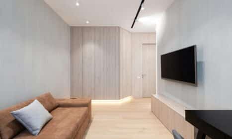 Sleek modern living room featuring a brown sofa and wall-mounted TV.