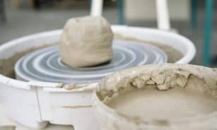A detailed view of wet clay on a pottery wheel, highlighting the craftsmanship involved in pottery making.