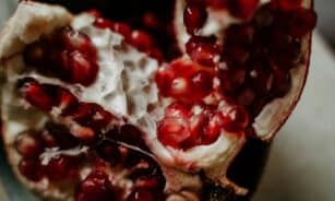 A close-up shot of fresh pomegranate seeds showcasing their vibrant red color and juicy texture.