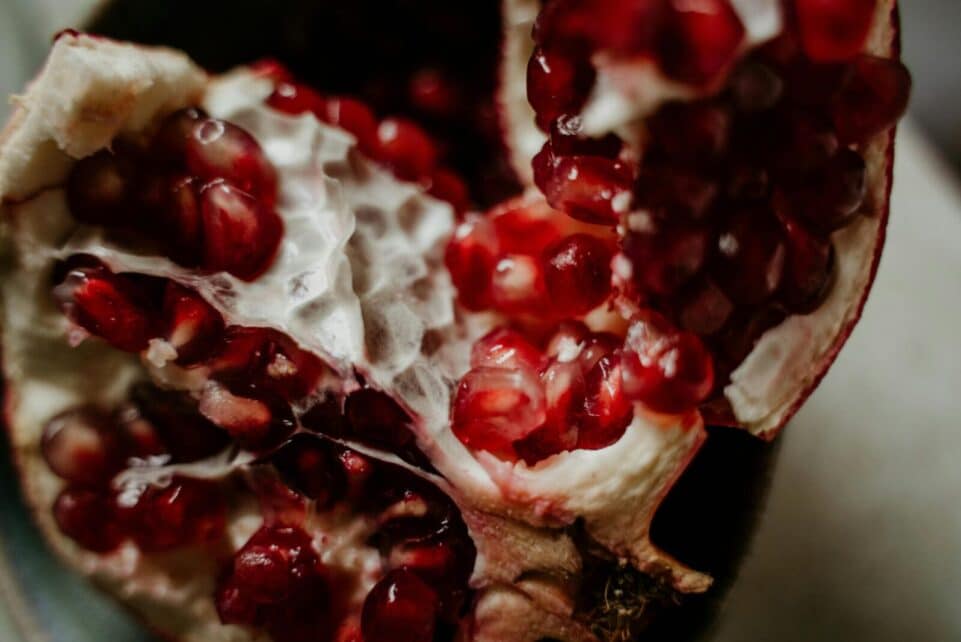 A close-up shot of fresh pomegranate seeds showcasing their vibrant red color and juicy texture.