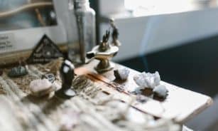 An enchanting arrangement featuring crystals and incense on a wooden surface, evoking tranquility and spirituality.