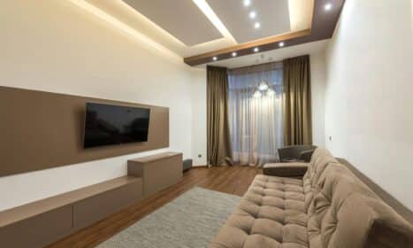 Spacious living room featuring modern design with cozy furniture and warm lighting.