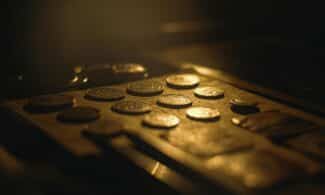 Close-up of vintage coins in warm lighting with artistic shallow focus.