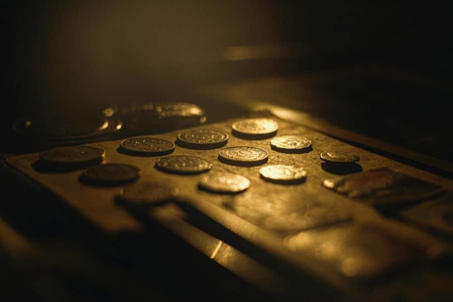 Close-up of vintage coins in warm lighting with artistic shallow focus.