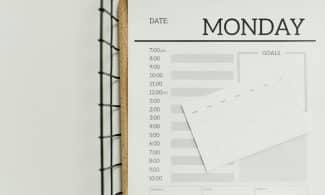 Top view of a minimalist schedule planner with Monday header. Perfect for organizing daily tasks with goals section.