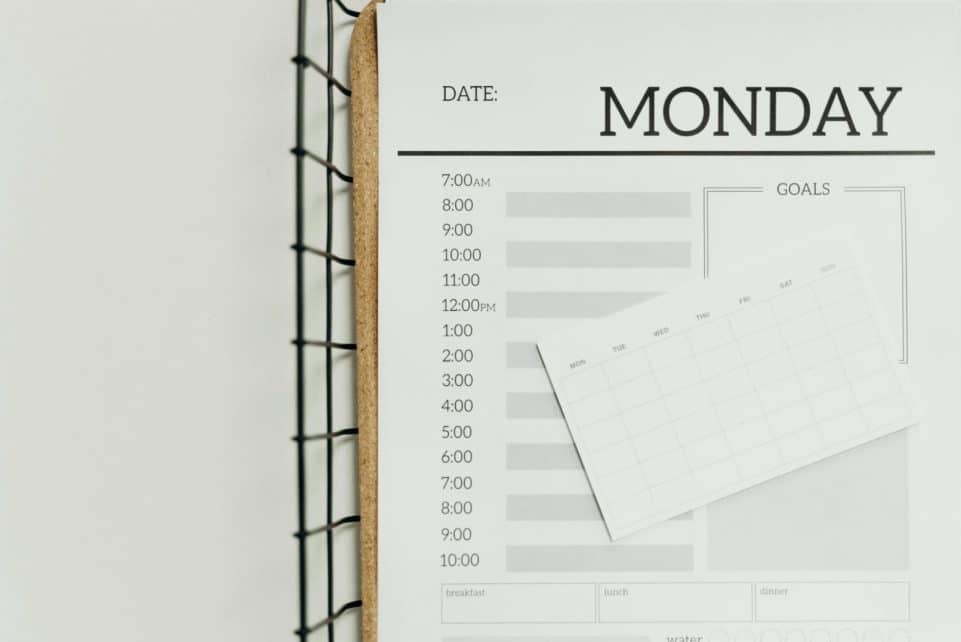 Top view of a minimalist schedule planner with Monday header. Perfect for organizing daily tasks with goals section.