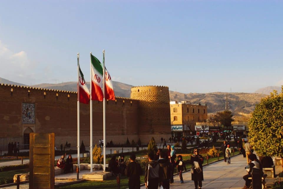 Karim Khan Citadel with Iranian flags in Shiraz, Iran at sunset.