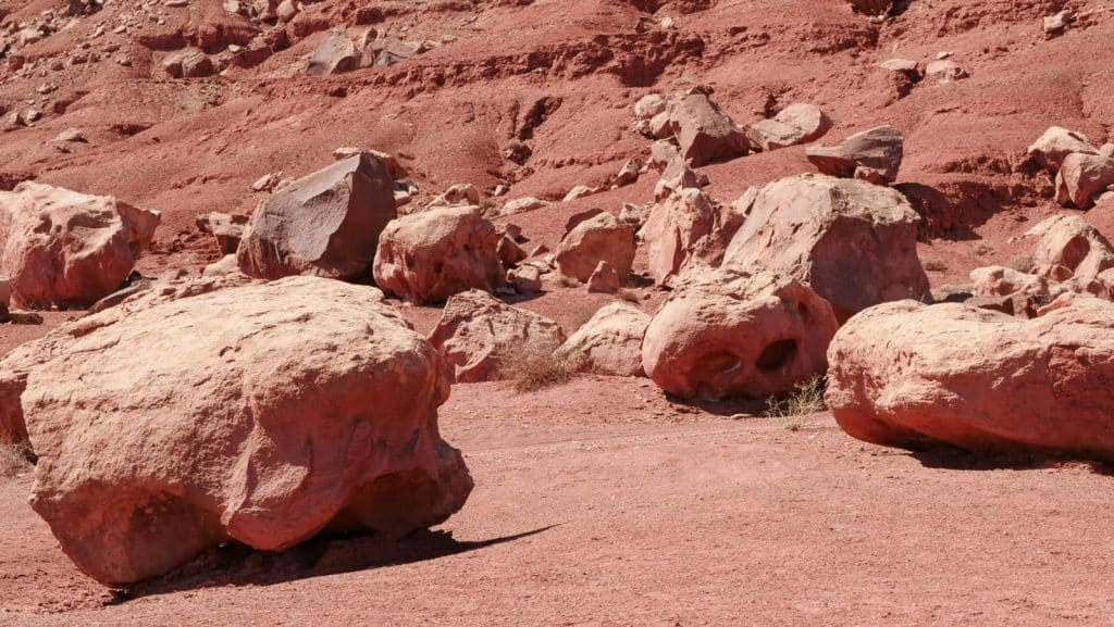 Rugged desert scene with red boulders resembling a Martian landscape.