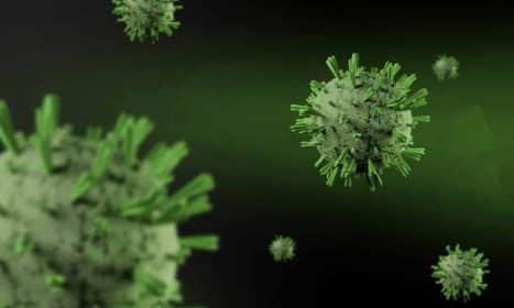 Close-up 3D render of virus particles floating on a dark green background, showcasing detailed virus structure.
