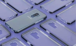 Close-up of a Samsung phone surrounded by transparent cases on a purple surface, showcasing modern technology.