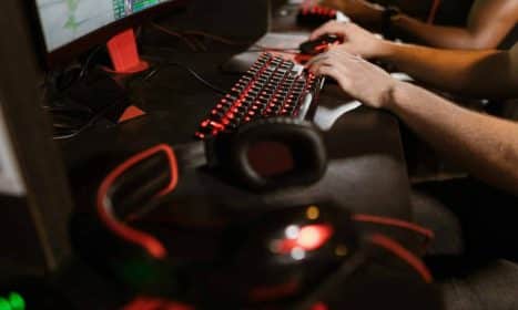 Close-up of gamers using mechanical keyboards during an intense esports session.