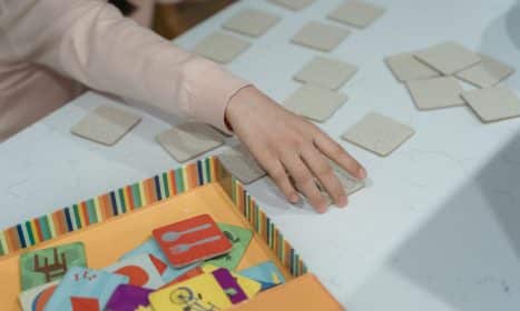 A child engages in a fun memory matching card game, showcasing focus and concentration.