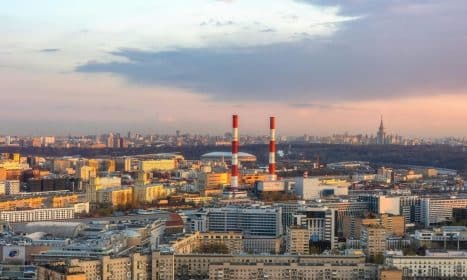 Stunning aerial view of Moscow skyline with industrial elements and cityscape flair at twilight.