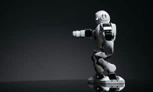 A white robot showcasing modern design on a sleek dark surface.