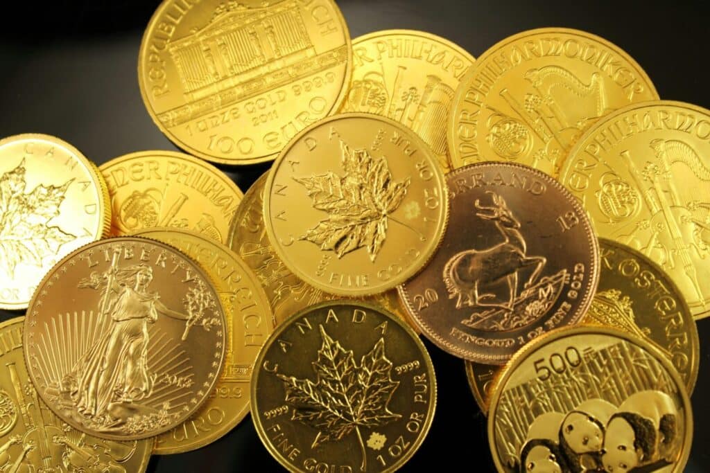 A detailed close-up of diverse gold bullion coins from different countries.