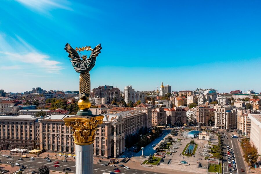 a view of a city with a statue in the middle