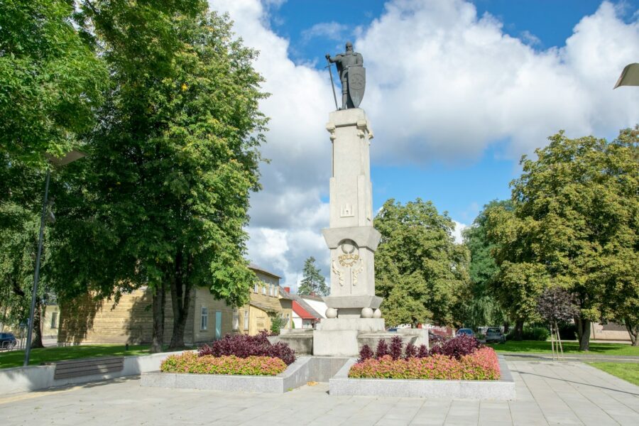 a monument with a statue of a man on top of it