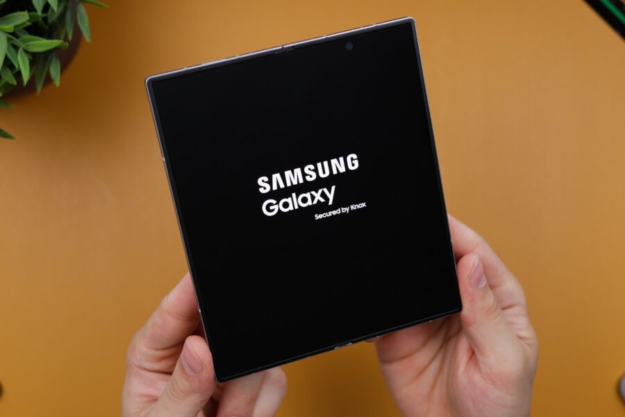 A person holding a black box with the samsung logo on it