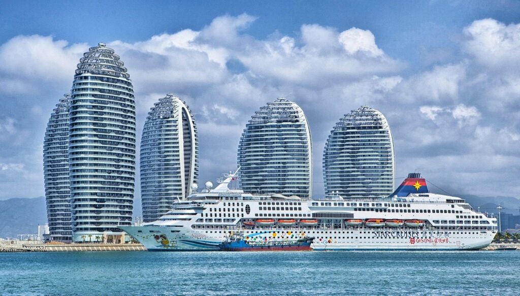 ship, city, harbor, port, nature, bay, water, skyscrapers, hotels, modern buildings, buildings, island, phoenix island, urban, skyline, ocean liner, passenger ship, cruise ship, superstar aquarius, sanya bay, hainan, china