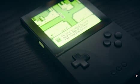 A handheld console displays a map on its screen.